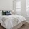 a bed with a white bed spread
