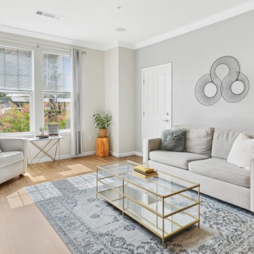 Beautiful living areas to match your lifestyle Model living room at Jefferson at Dedham Station apartments in Dedham, MA, featuring wood grain floor paneling.