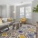 Model living room at Jefferson at Dedham Station apartments in Dedham, MA, featuring couches and windows with blinds.