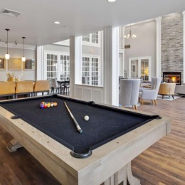 The resident lounge at Jefferson at Dedham Station Apartments in Dedham, MA, featuring a billiards table.