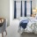 a bedroom with a bed desk and a chair