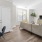 Model living room at Jefferson at Dedham Station apartments in Dedham, MA, featuring wood grain floor paneling.