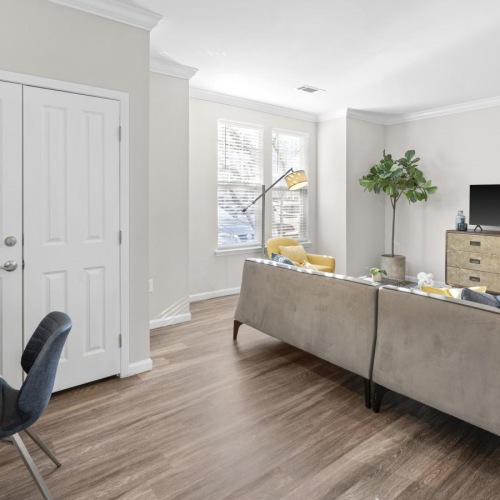 Beautiful living areas to match your lifestyle Model living room at Jefferson at Dedham Station apartments in Dedham, MA, featuring wood grain floor paneling.