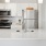 Model kitchen at our apartments for rent in Dedham, MA, featuring stainless steel appliances and white counters.